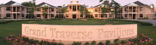 A serene view of the Traverse Bay Education Complex, showcasing its elegant architecture amidst a green landscape.