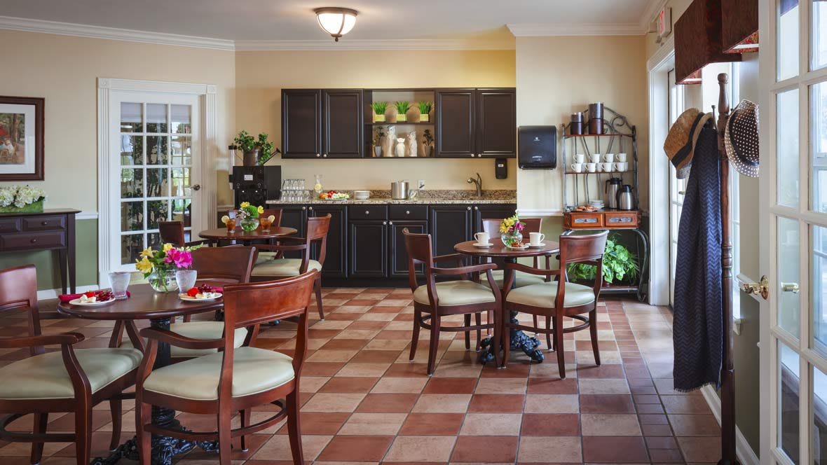 A cozy dining area with dark cabinets and wooden furniture.