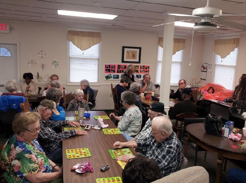 Seniors enjoying a bingo game in a community center setting.