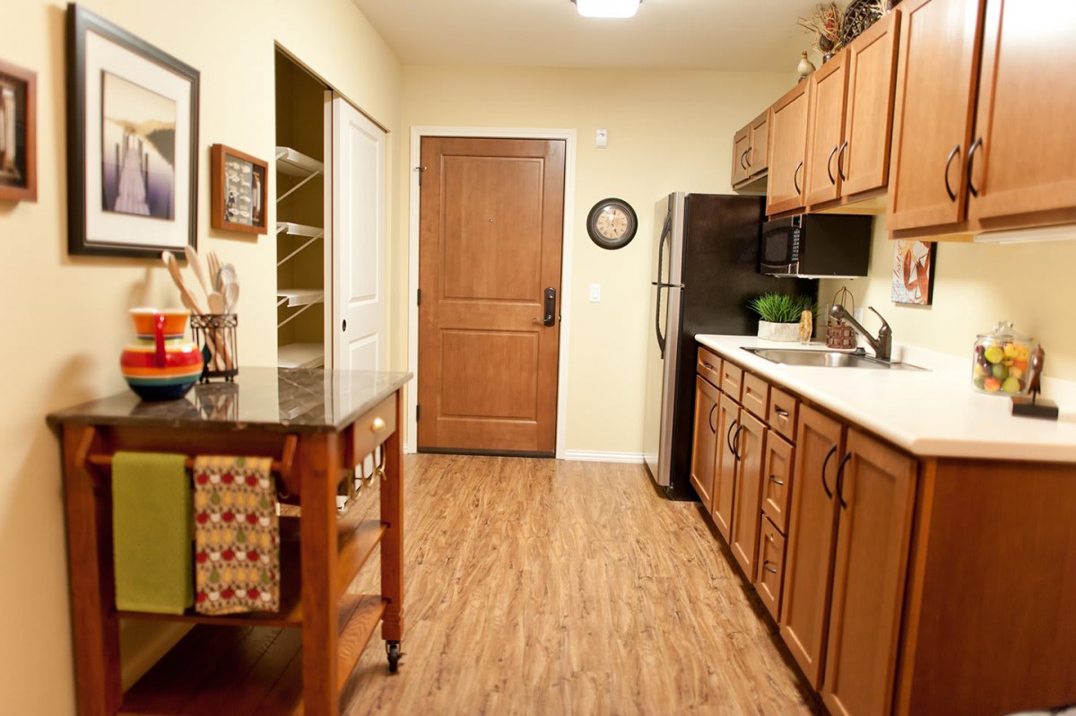 A cozy kitchen with wooden cabinets and a central island.