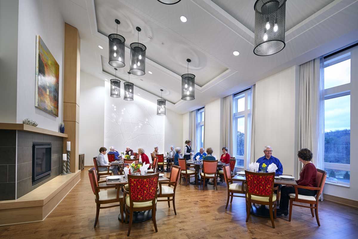 A group of people dining in a well-lit restaurant with modern decor.