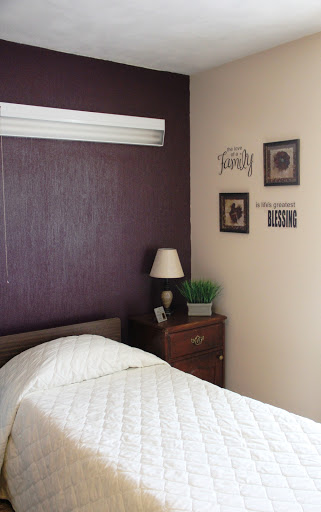A cozy and stylish bedroom featuring a warm color palette, tasteful decor, and a comfortable bed.