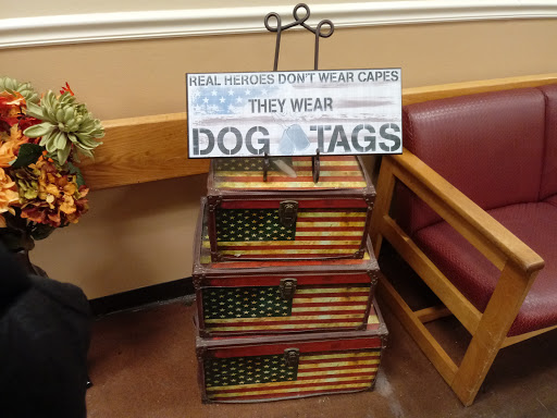 A decorative stand featuring a sign about dog tags, emphasizing their importance for service dogs.