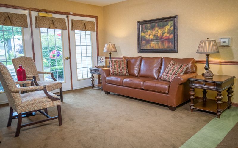 A cozy living room with a brown leather sofa and stylish decor.