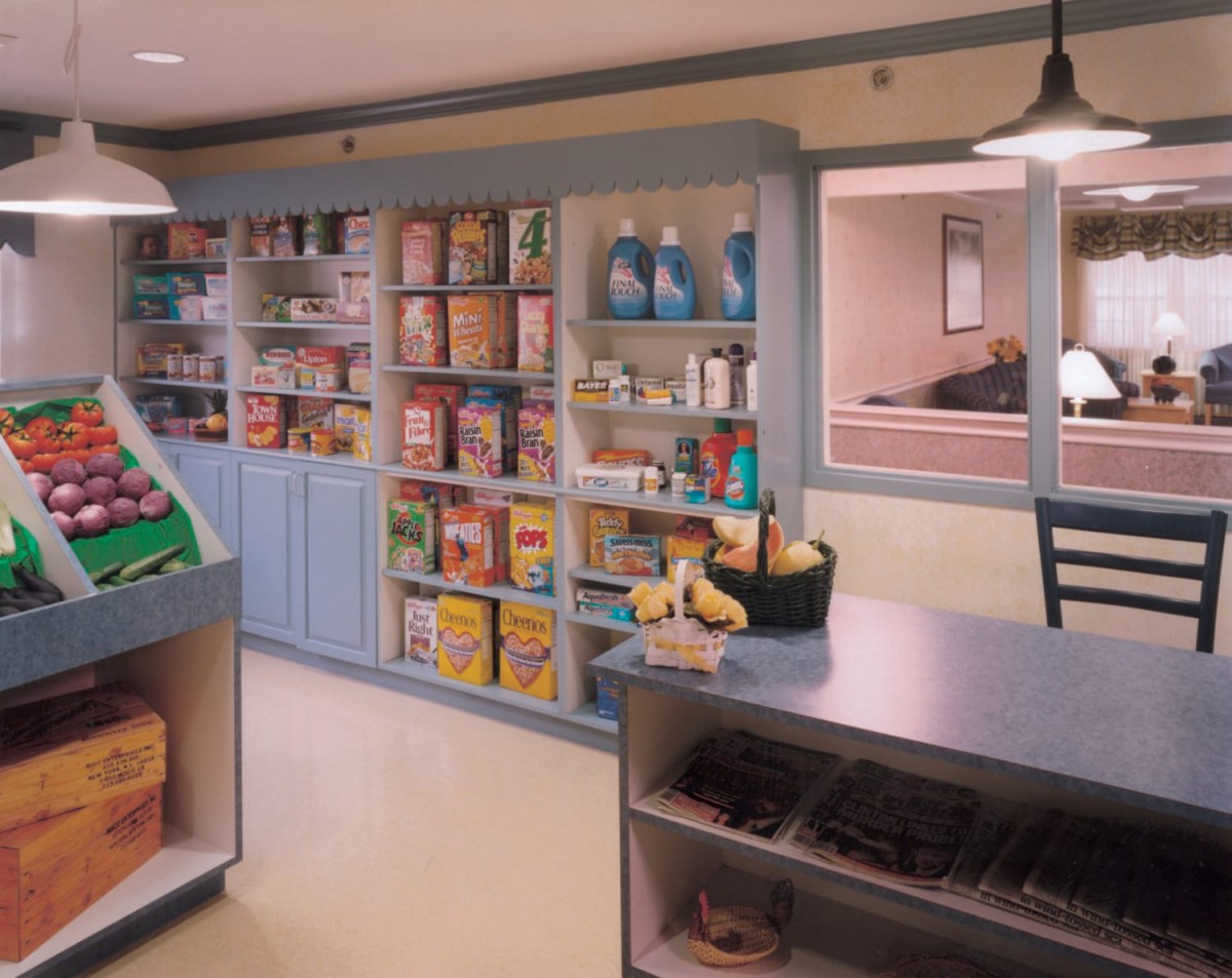 A cozy grocery store interior with neatly arranged shelves filled with various products and cereals.
