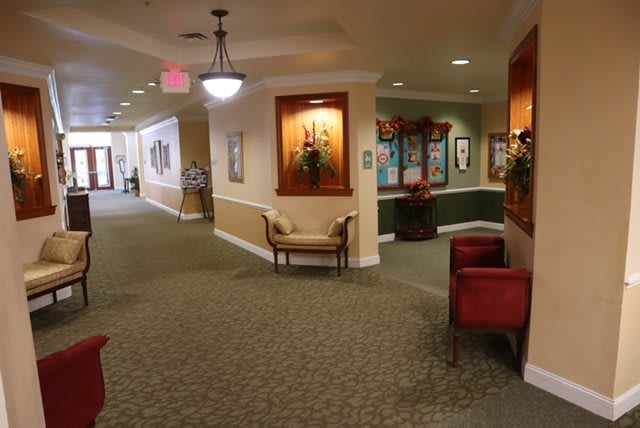 A well-lit hallway with seating and decorative elements.
