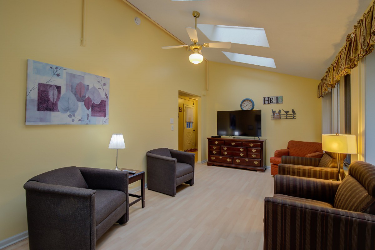 A cozy living room featuring comfortable seating, a television, and stylish decor.