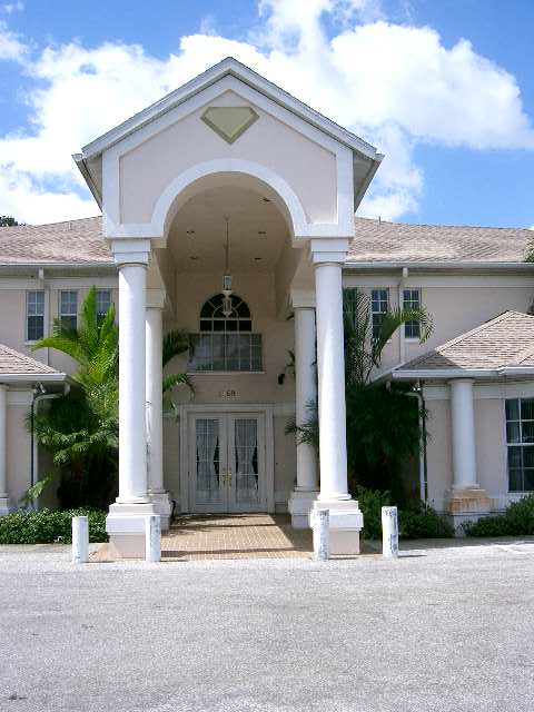 A luxurious mansion with grand columns and an elegant entrance.
