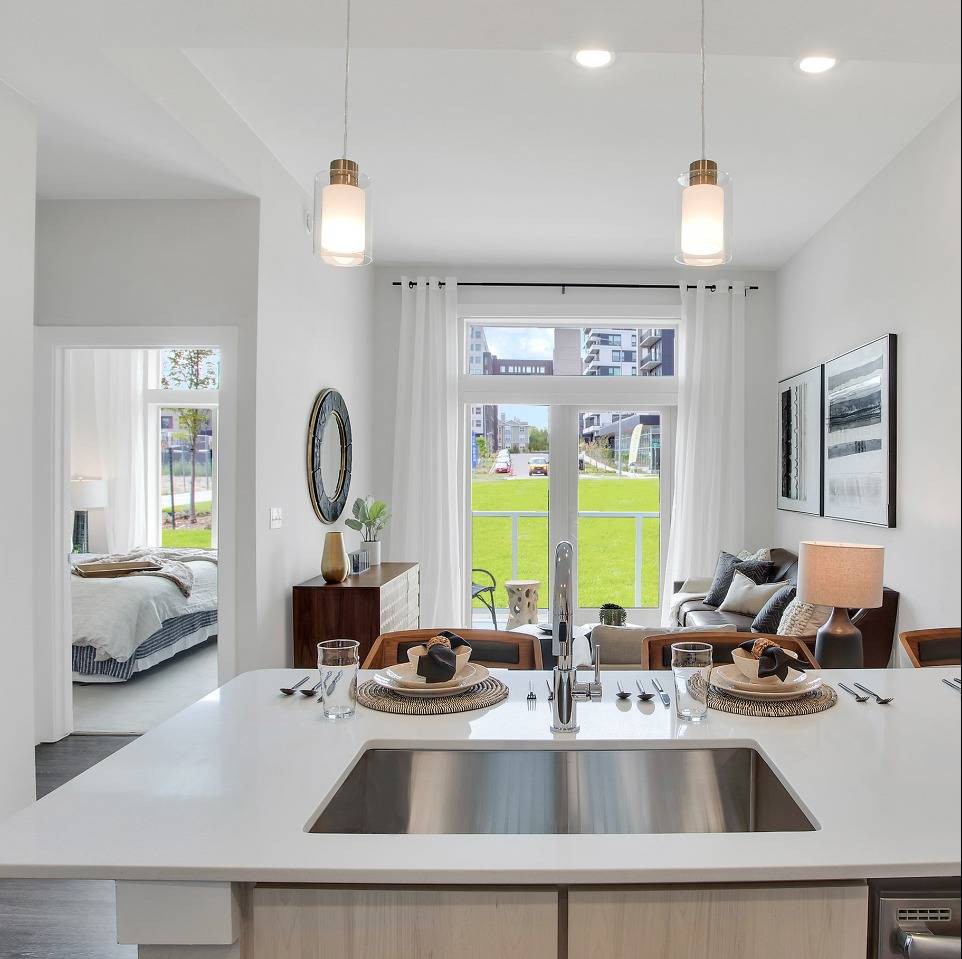 Modern open-plan kitchen and living room with natural lighting.