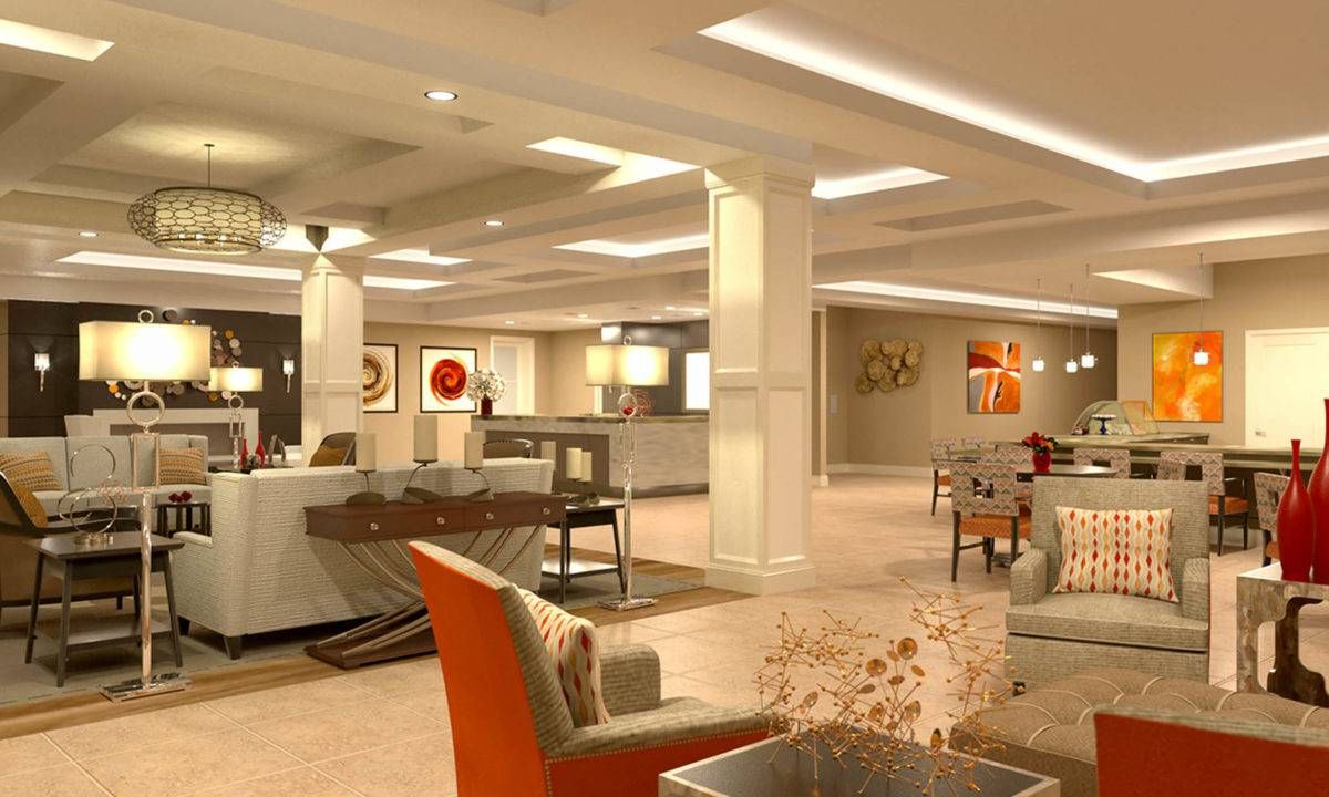 A modern and well-lit lobby area featuring comfortable seating and artwork on the walls.