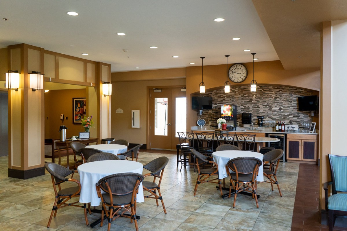 A cozy dining area with neatly arranged tables and a bar counter.