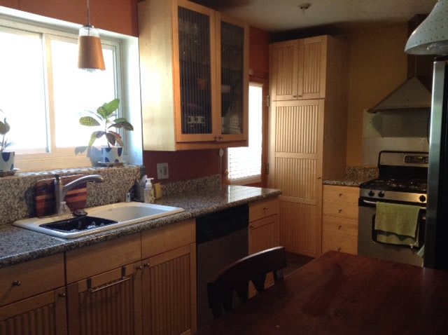 A cozy kitchen with wooden cabinets and modern appliances.