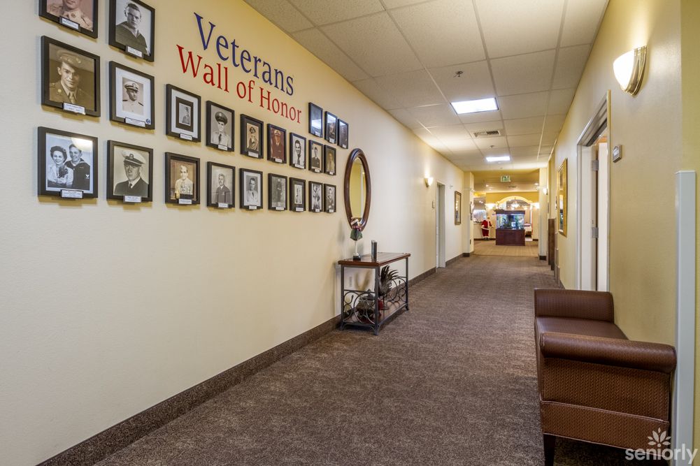 A hallway with a Veterans Wall of Honor featuring framed photos.