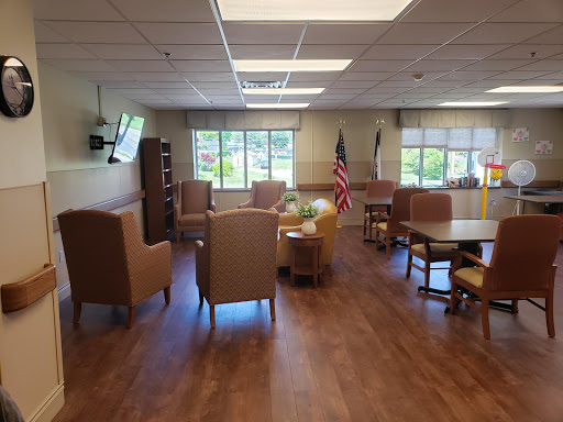 A cozy lounge area featuring comfortable seating, natural light from the windows, and a welcoming atmosphere.