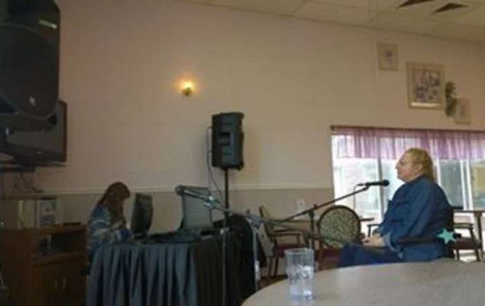 An indoor event setup with a microphone and speaker on stage.