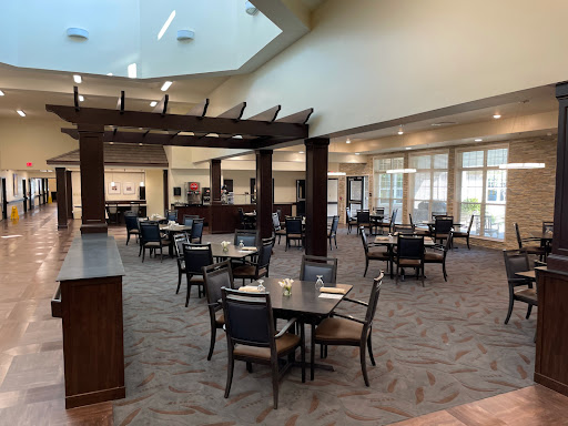 A spacious and modern dining area with tables and chairs arranged for guests.