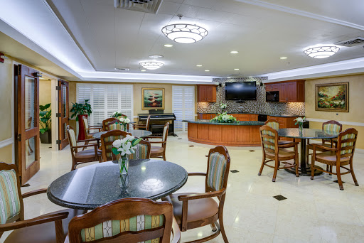 A cozy and inviting common area featuring comfortable seating and dining options.