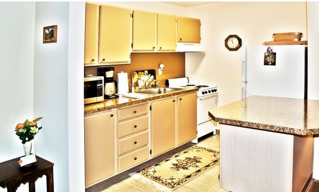A cozy kitchen with wooden cabinets and modern appliances.