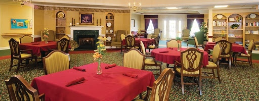 An elegant dining room featuring red tablecloths and comfortable seating, perfect for a cozy meal.