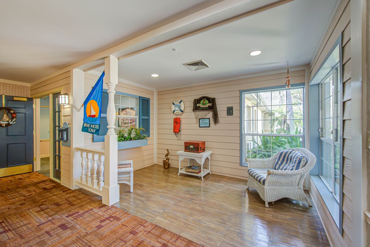A cozy living space featuring wooden floors, comfortable seating, and homey decor.