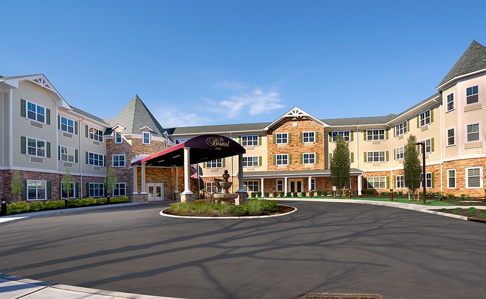 A large residential building with a welcoming entrance and landscaped surroundings.