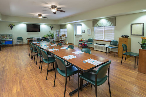 A spacious meeting room equipped with a long table and chairs, ideal for collaborative discussions.