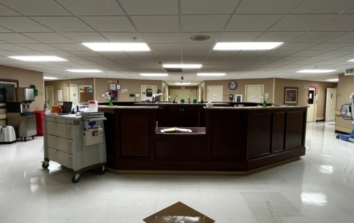 View of a hospital nurse station with medical equipment and reception area.