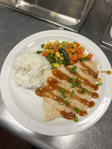 A delicious plate featuring sauted vegetables, rice, and a sauced dish.