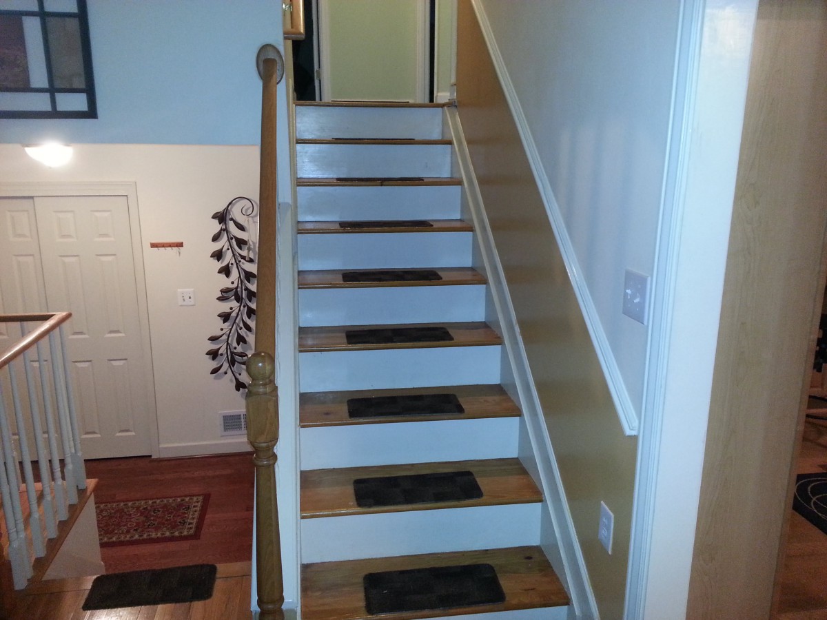 A stairway with carpeted steps inside a home.