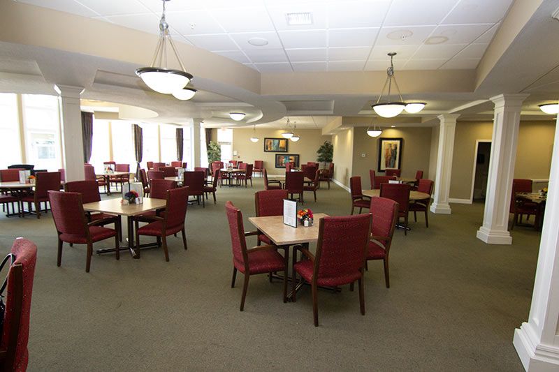 A spacious dining area with neatly arranged tables and chairs.