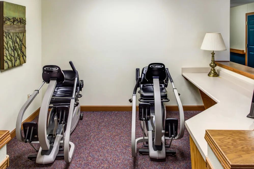 A small fitness room featuring two stationary exercise bikes.