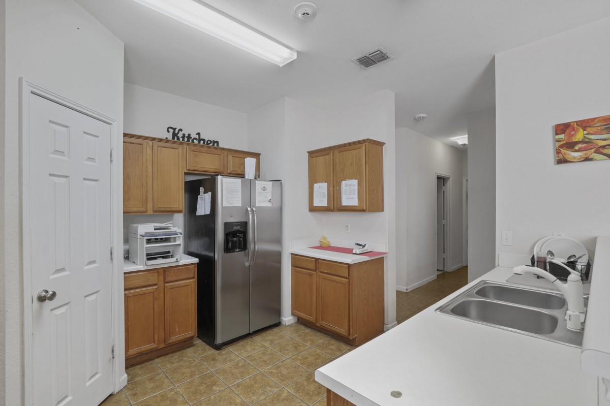 Modern kitchen with wooden cabinets and stainless steel appliances.