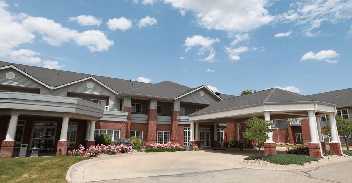 A residential building with a brick exterior and landscaped surroundings.