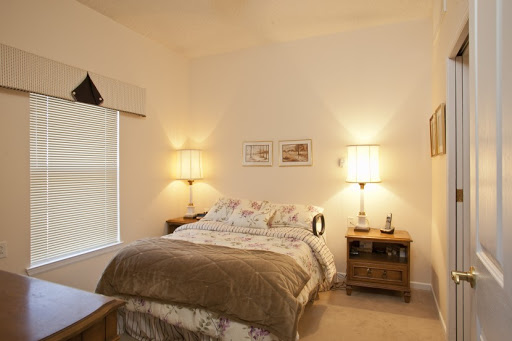 A cozy and well-lit bedroom featuring a comfortable bed, stylish lighting, and simple decor.
