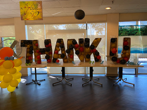 A vibrant display of letters spelling 'THANK YOU' at a celebration event.