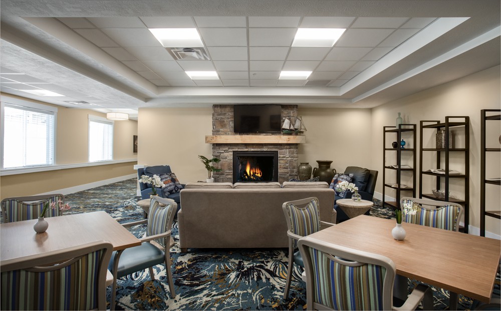 A cozy lounge area with a fireplace and comfortable seating.