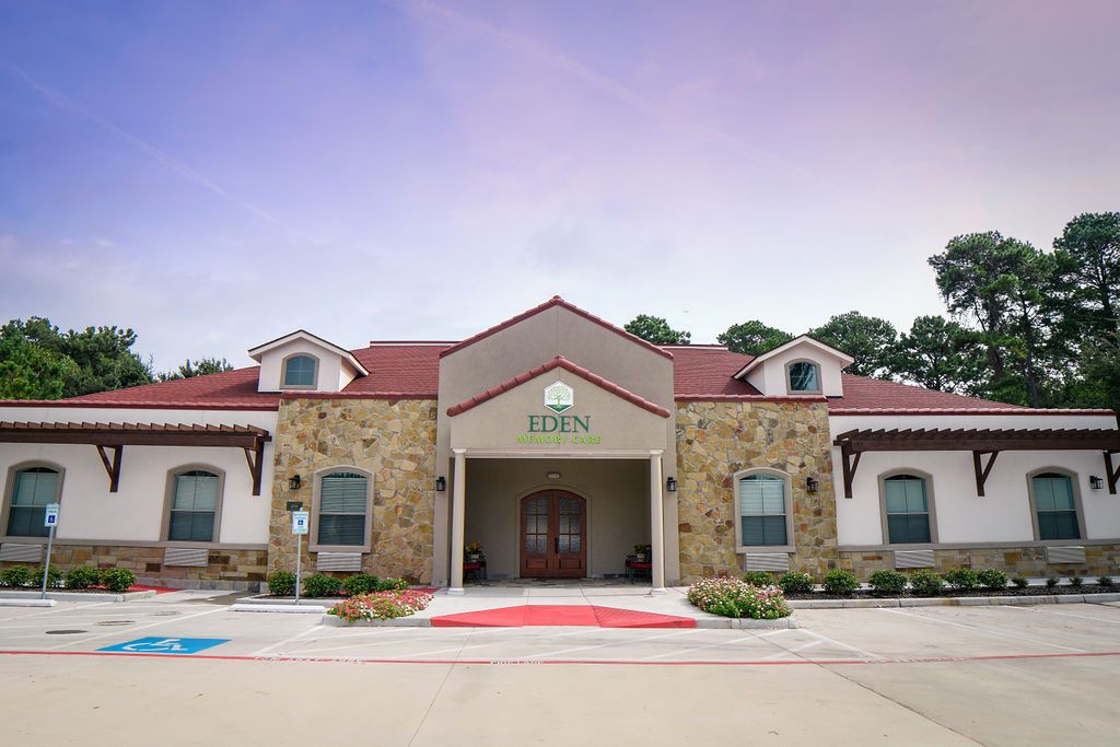 A charming building with a stone facade and red roof set against a serene sky.