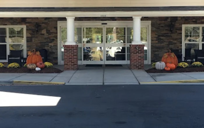 Entrance of a building decorated with pumpkins for autumn.