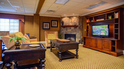 A cozy living room featuring comfortable seating, a fireplace, and a stylish entertainment unit.