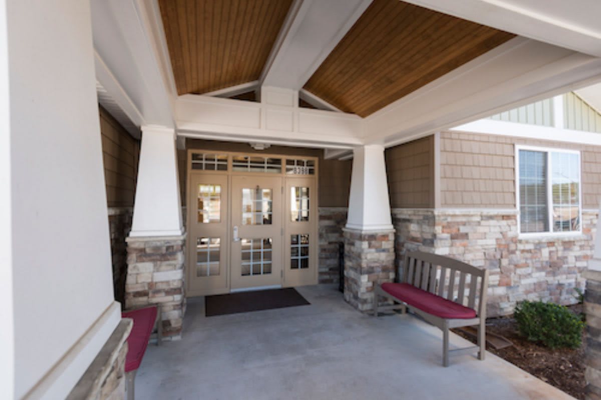 Building entrance with stone walls and benches.