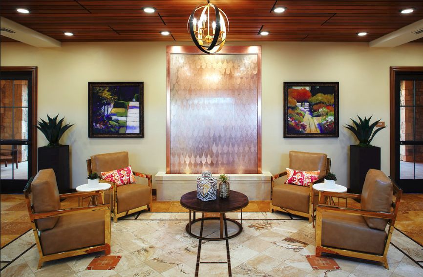 A modern living room with comfortable seating, stylish artwork, and warm lighting.
