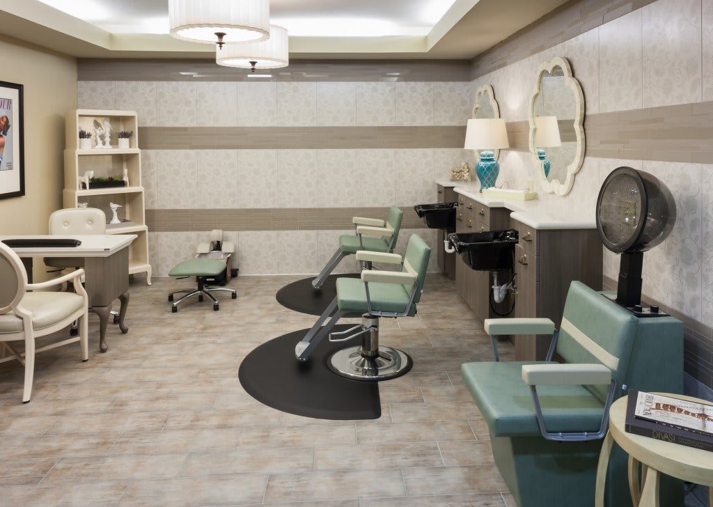 A modern beauty salon interior with stylish barber chairs and mirrors.