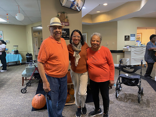 A joyful moment shared among friends, all dressed in coordinating orange outfits.