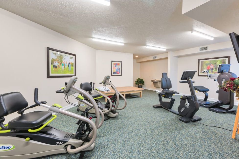 A small gym room equipped with treadmills and a stationary bike.