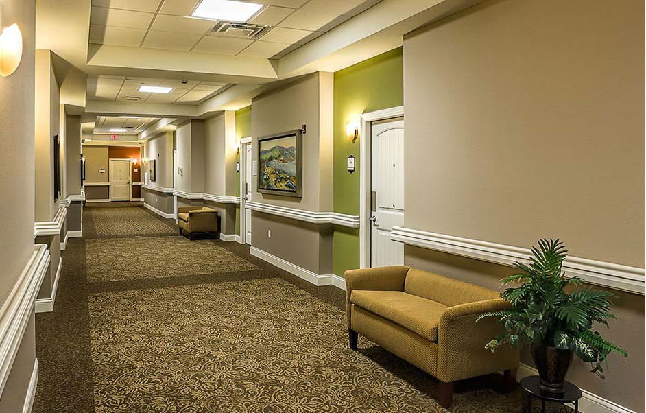 A well-lit hallway with carpeted flooring and comfortable seating.