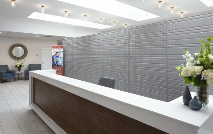 A modern reception desk in a well-lit office with a sleek design.