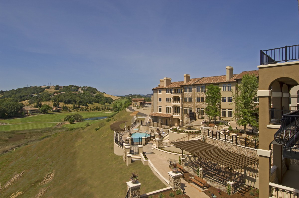 A luxurious resort hotel with a pool and scenic landscape view.