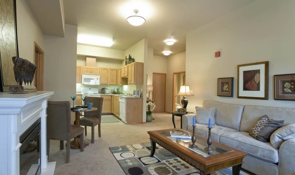 A cozy apartment interior featuring an open living room and kitchen layout.