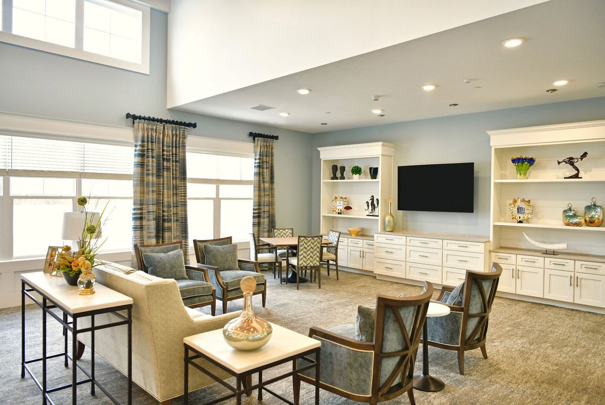 A modern living room with comfortable seating, a large television, and elegant decor.