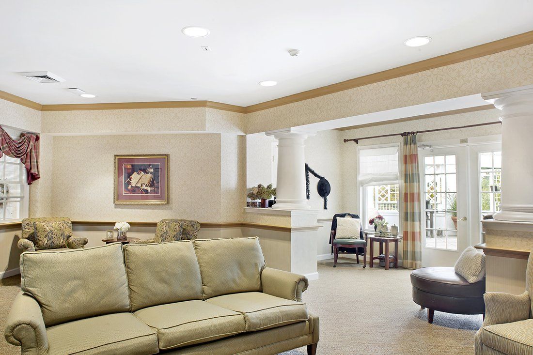 A cozy living room with a beige sofa, artwork on the wall, and elegant decor.